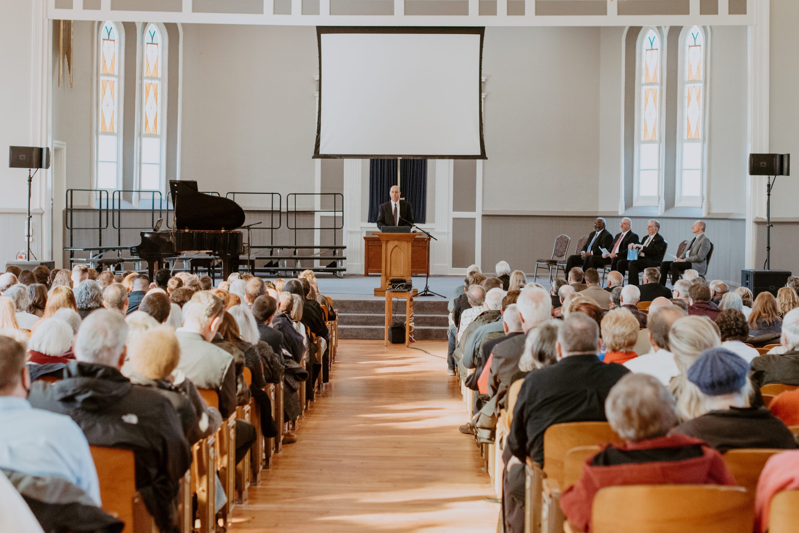People gathered in the pews of Collier Chapel for a service