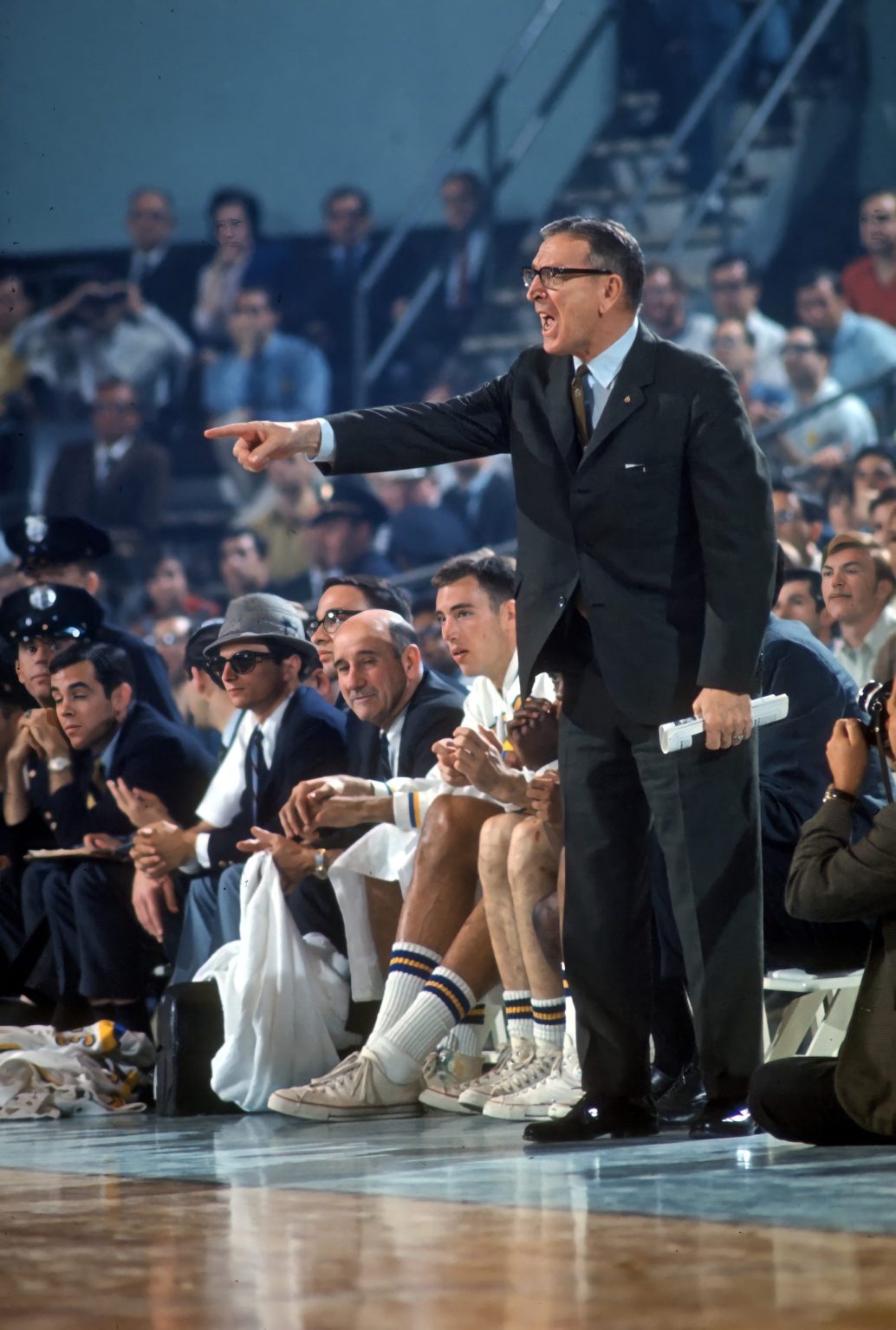 Coach John Wooden standing and pointing