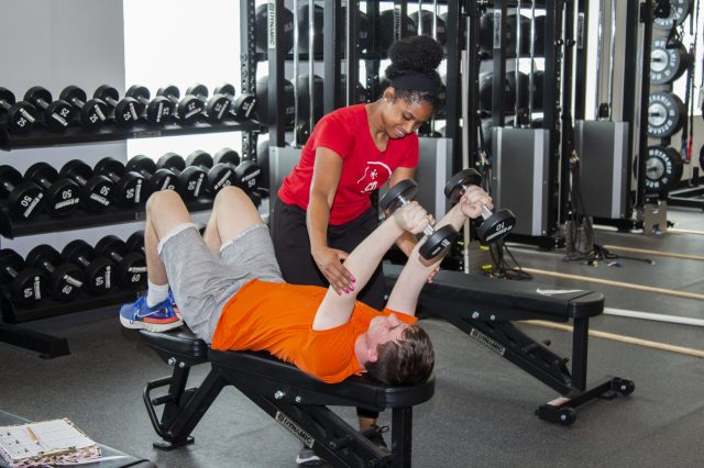 Trainer working with an athlete in the AIA Sports Performance Center