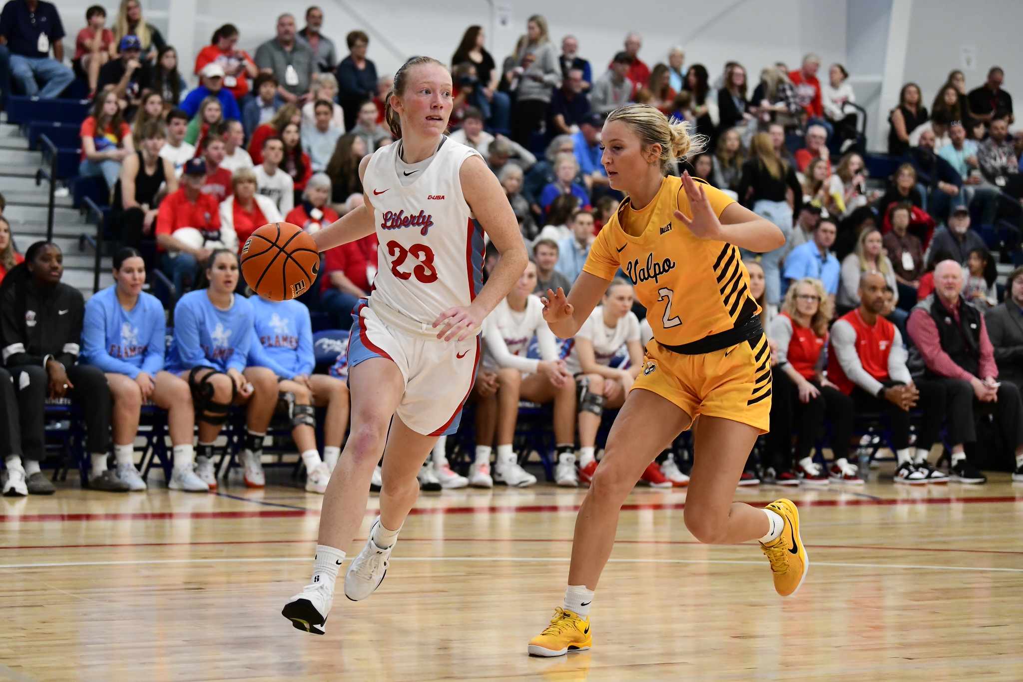 Women’s basketball players racing up the court in the John Wooden Family Fieldhouse