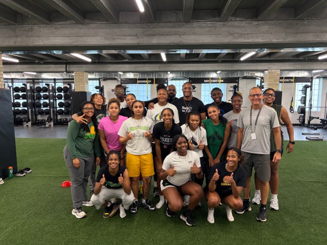 College women’s basketball team smiling together during a team retreat