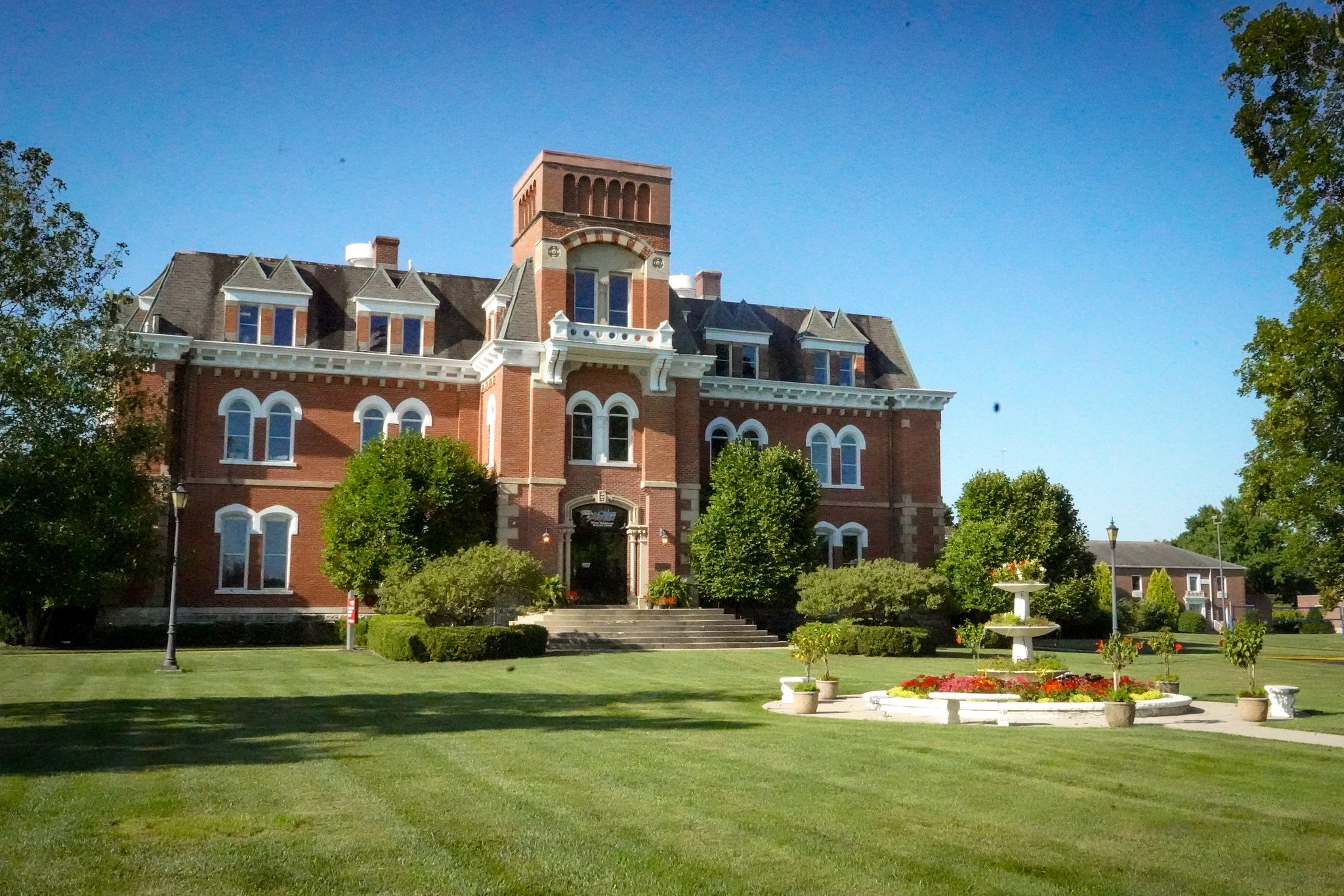 Historic red brick building with a bell tower on the AIA campus in Xenia, Ohio